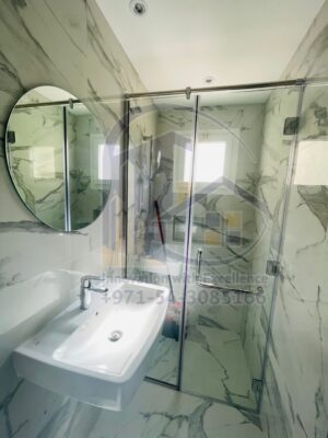 shower enclosure with round mirror installation